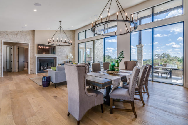 Hardwood floors and medieval style chandeliers in spacious family room