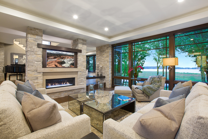 A modern family room with a spectacular view of a lake