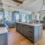 Large chandeliers accentuate ceiling in kitchen