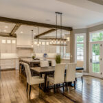 Wood beams on ceiling with two pendant lights hang over island